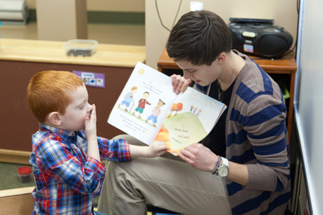 teacher reading to boy